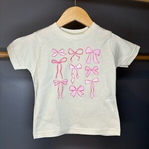 Cream t-shirt with pink bow design